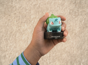 child holding the Pokémon Bulbasaur Tonie