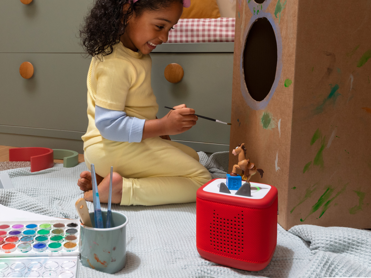 Child painting and playing with Disney and Pixar Toy Story 5- Bullseye Tonie and a red toniebox 2