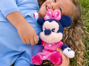 Child playing with minnie mouse cuddle Tonie audio figurine and Toniebox 2