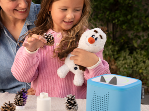 Child playing with olaf cuddle Tonie audio figurine and Toniebox 2