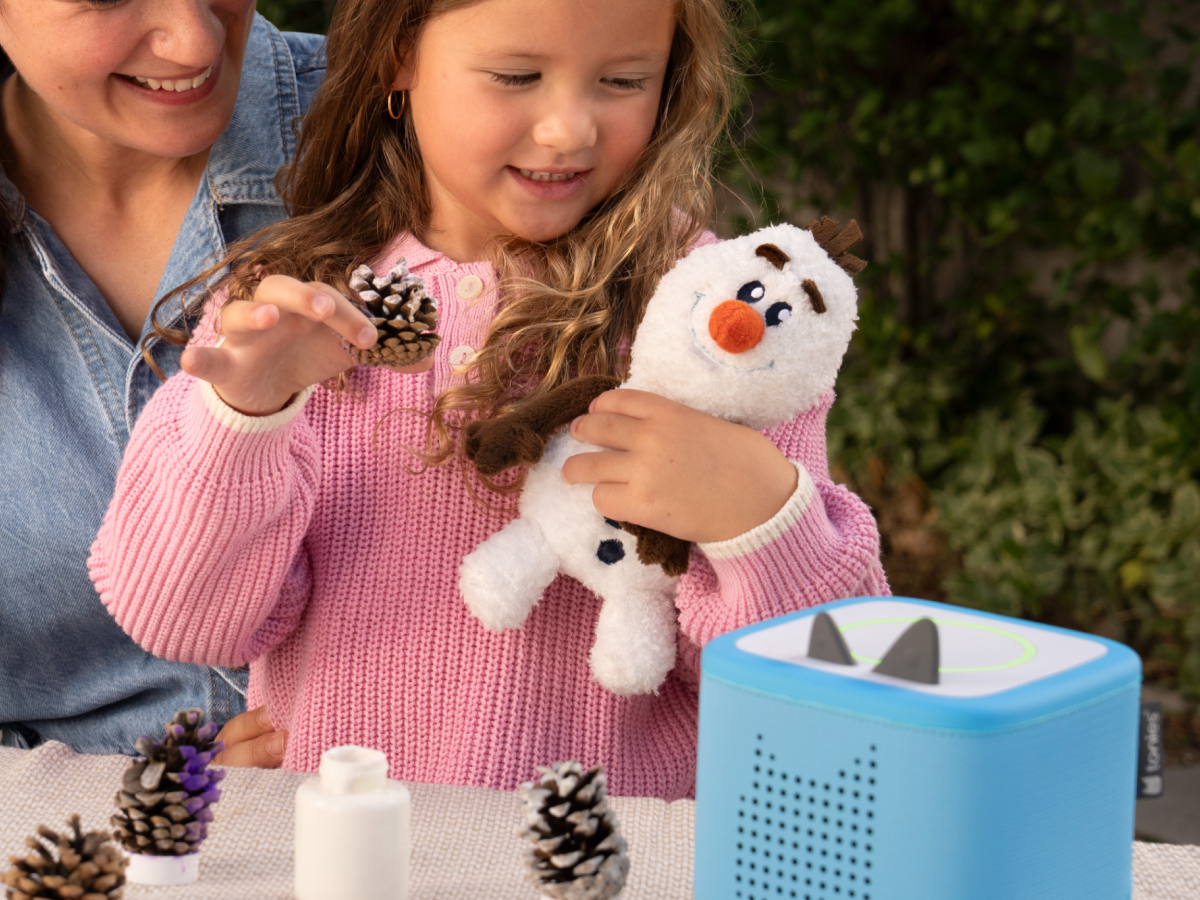 Child playing with olaf cuddle Tonie audio figurine and Toniebox 2