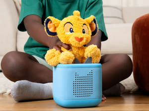 Child playing with Cuddle Tonie- Disney SimbaTonie audio figurine and Toniebox 2
