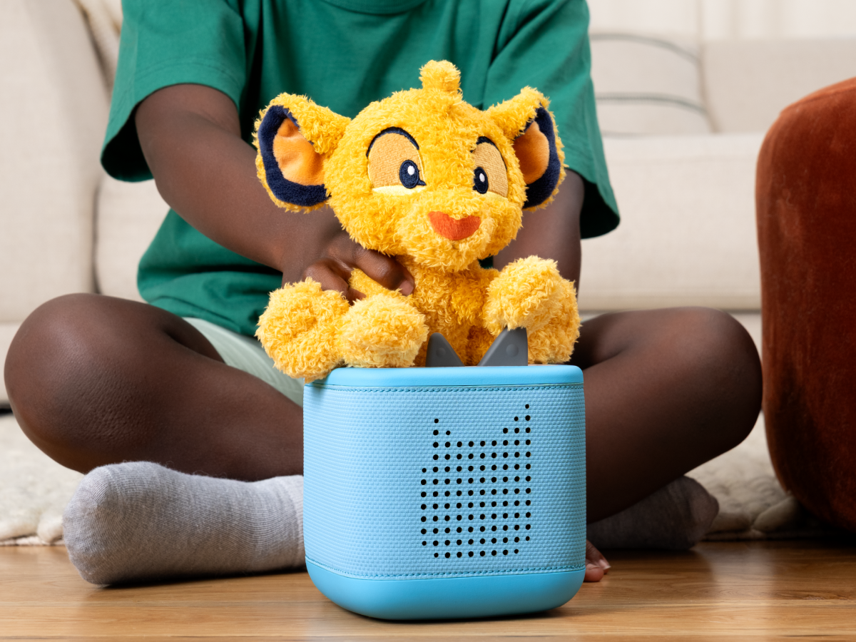 Child playing with Cuddle Tonie- Disney SimbaTonie audio figurine and Toniebox 2