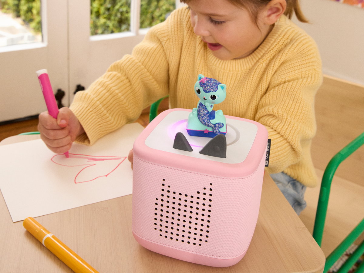 Child Playing With Mercat Tonie Audio Figurine And Toniebox 2