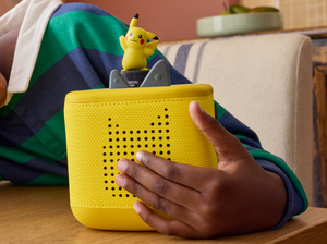 child holding the Pokémon Pikachu Tonie and a toniebox 2