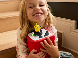 child holding the Pokémon Pikachu Tonie and a toniebox 2