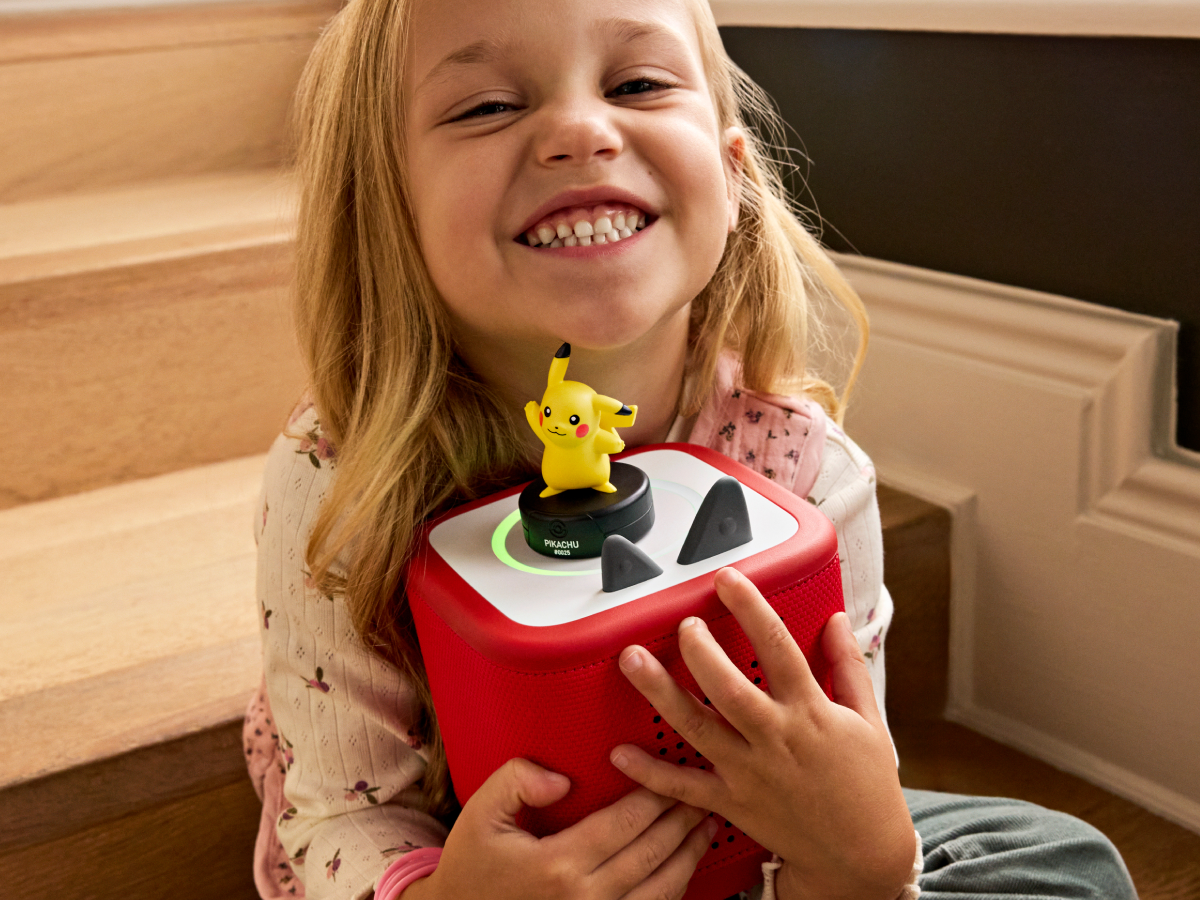 child holding the Pokémon Pikachu Tonie and a toniebox 2