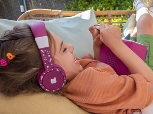 Child Using The Toniesâ® Purple Wired Headphones For Kids