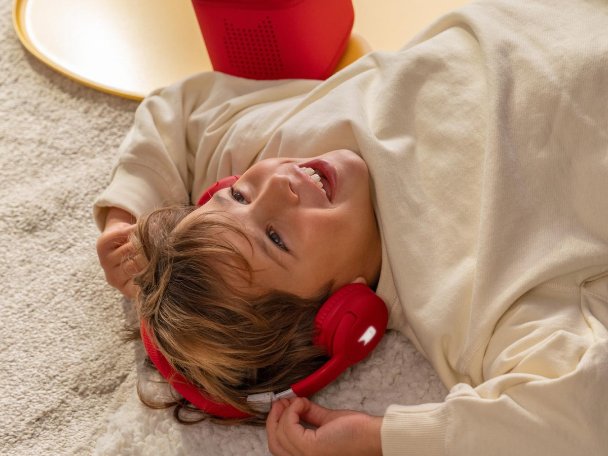 Child Listening To The Toniebox 2 And Tonie With Red Bluetooth Headphones For Kids