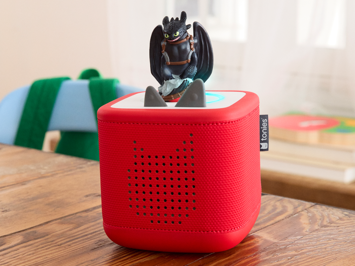 Child playing with How to Train Your Dragon: Toothless Tonie audio figurine and Toniebox 2