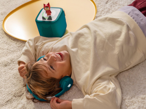 Child Listening To The Toniebox 2 And Tonie With Teal Bluetooth Headphones For Kids